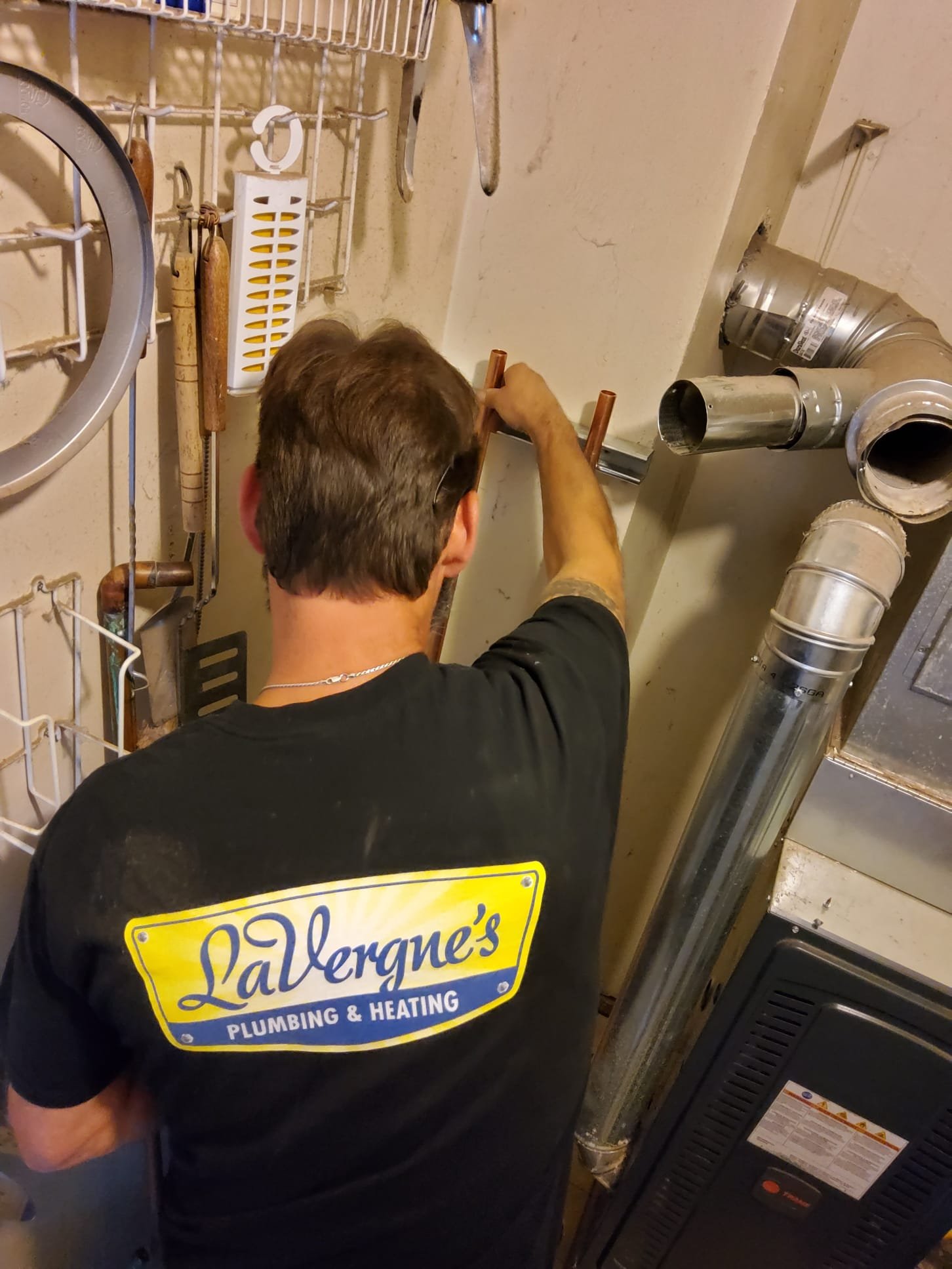 LaVergne's technician feeding a rooter cable into a residential sewer cleanout