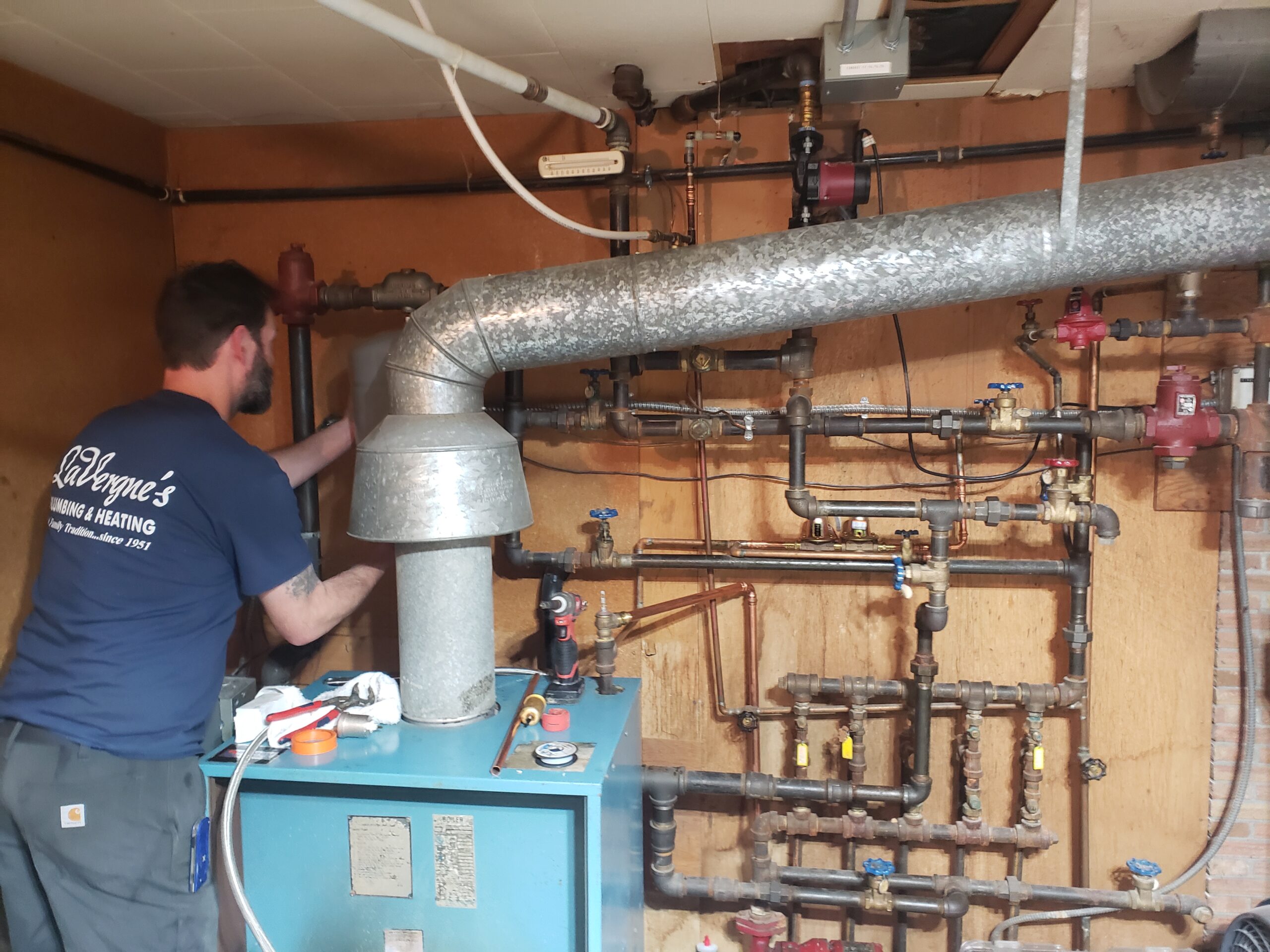 LaVergne's HVAC technician diagnosing an outdoor heat pump unit at a local home
