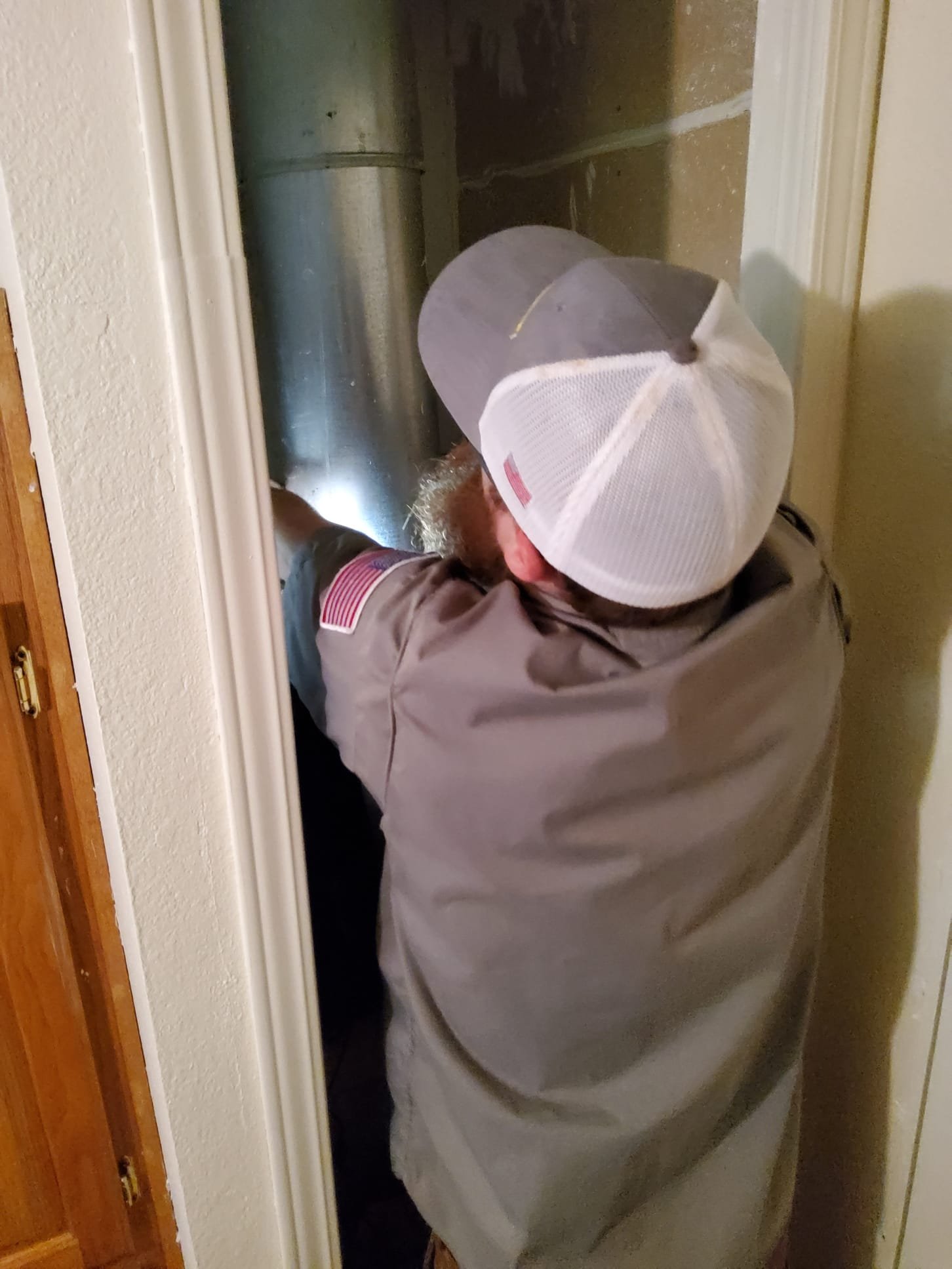 LaVergne's technician testing flow sensor operation on a wall-hung tankless unit
