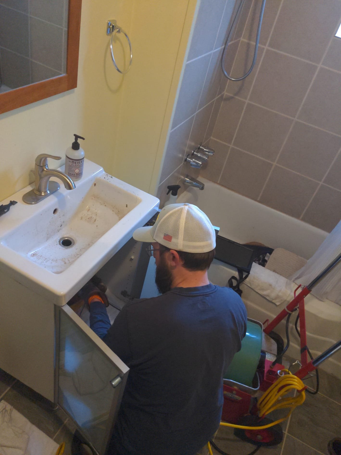 LaVergne's technician performing seasonal maintenance on a residential heat pump