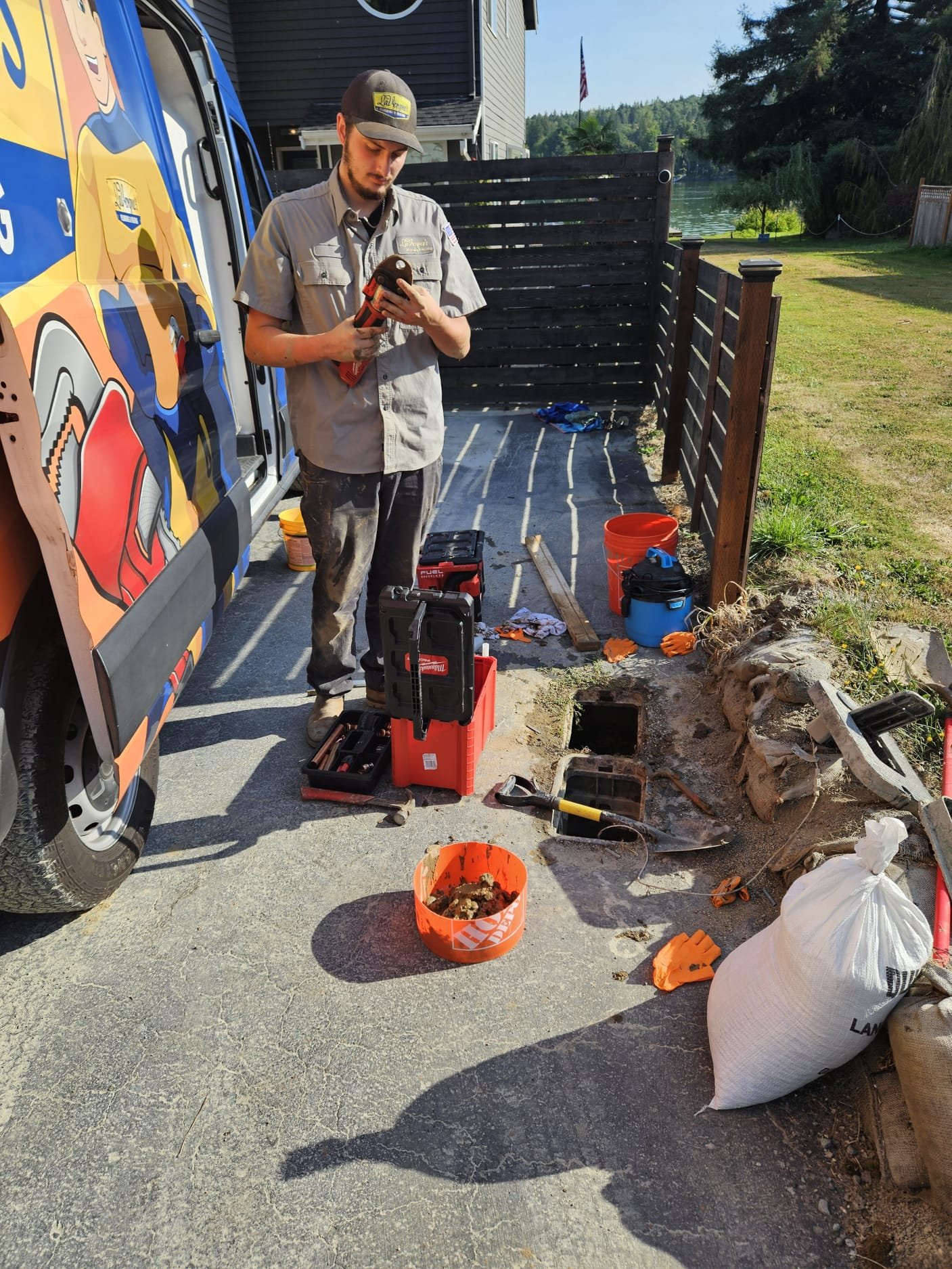 LaVergne's technician performing a septic component repair at an exposed distribution box