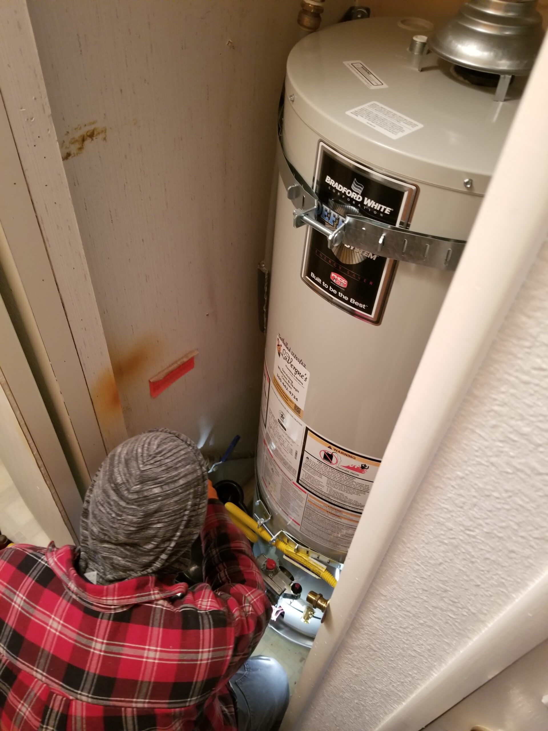 Heat pump outdoor unit installed beside a rural home that previously heated with propane