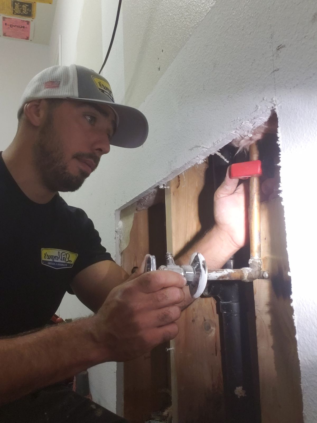 Anode rod condition being evaluated during a LaVergne's water heater tune-up