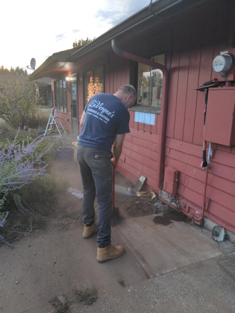 LaVergne's technician recording heat pump performance readings during a fall tune-up